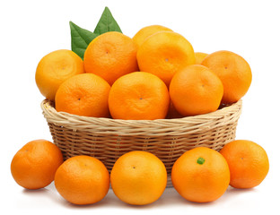 Fresh tangerines in a basket isolated on white