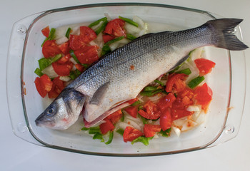 Bass in his dish and vegetables garnish