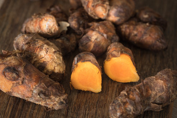 Turmeric on chopping board, whole pieces and cut in half