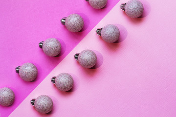Holiday composition. Christmas balls on a pink and purple background, diagonal, hard shadows. Christmas, New Year concept. Top view, flat lay, mock up, mockup, copy space.