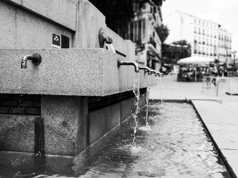Public drinking water fountain in Black and White photo. 