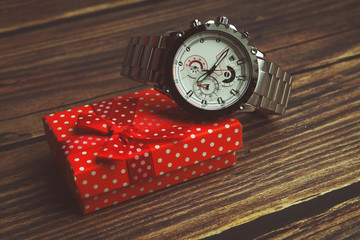 Men's wrist metal watch on white background with gift box	