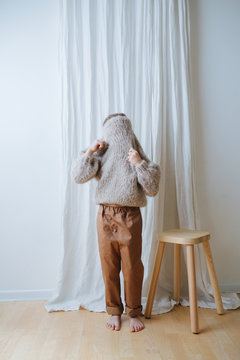 Little Girl Putting On Sweater, She Pulled It Over Head, Looking Through Holes