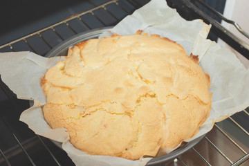 Cooking apple pie. The finished cake is taken out of the oven.