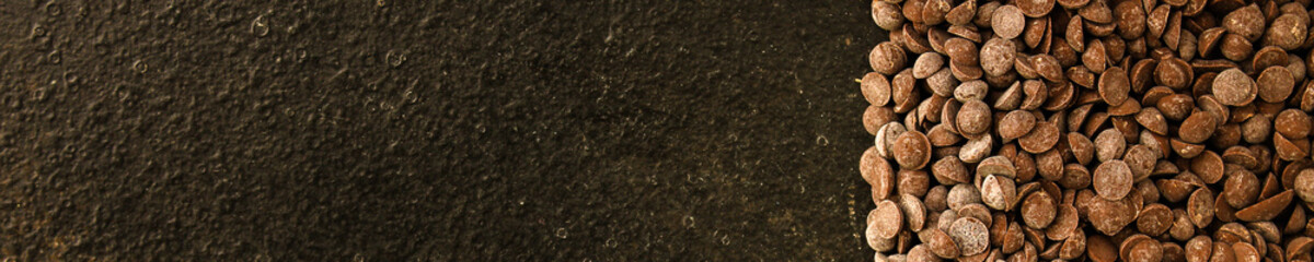 chocolate drops (black or milk chocolate, sweet ingredient) menu concept. food background. copy space. Top view