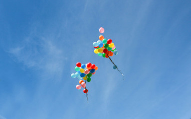 many multicolored balloons in a blue sky