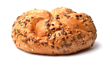 Wholemeal fitness bun with seeds and grains isolated on white background.