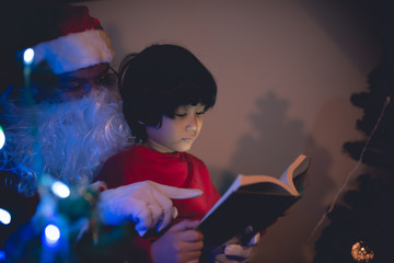 Santa clause reading tale for kid at christmas festival  at home,Thailand people