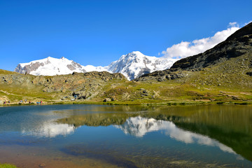 Naklejka na ściany i meble Reflection of the majestic Swiss Alps in the Riffelsee Lake, near the Gornergrat Ridge, Zermatt, Switzerland