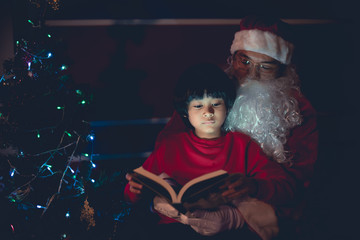 Santa clause reading tale for kid at christmas festival  at home,Thailand people