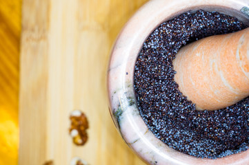 handmade preparation of treats for traditional Orthodox Christmas - mortar with poppy seeds, dried...