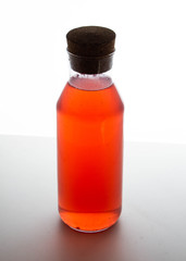 bottle with sweet water, drink for children, transparent glass, white background