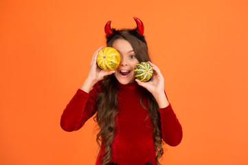 November holidays and fun days. Happy child with red demon horns hold pumpkins. November 1. All Saints Day. Halloween. November 20. International childrens day. November 27. Thanksgiving. Be thankful
