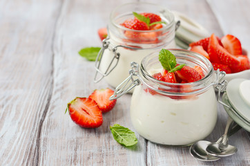 Homemade natural yogurt with strawberries and mint, selective focus.