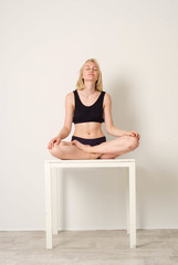 beautiful white girl in underwear sitting in lotus position. meditation. om .