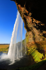 Fototapeta na wymiar Seljalandfoss waterfall in sunny autumn day, Iceland, Europe. Famous tourist attraction
