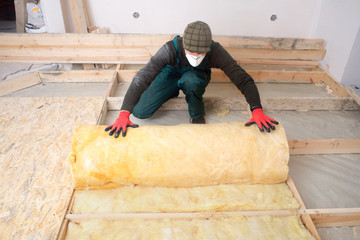 Work composed of mineral wool insulation in the floor, floor heating insulation , warm house,...