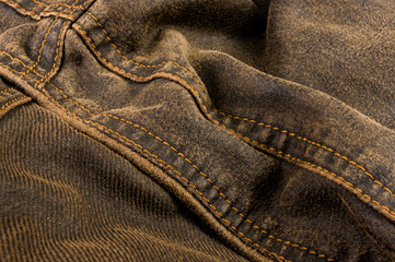 clothing items stonewashed cotton fabric texture with seams, clasps, buttons and rivets, macro