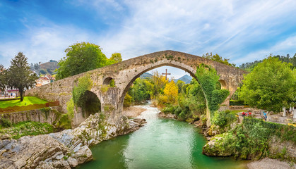 Fototapeta na wymiar Roman hump-backed bridge on the Sella River in Cangas de Onis, Asturias, Spain
