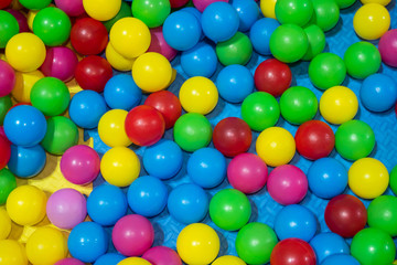 Fototapeta na wymiar Small multi-colored plastic balls. Background from spheres for children.