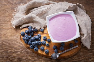 bowl of blueberry yogurt with fresh berries, top view