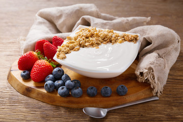 bowl of yogurt with granola and fresh berries