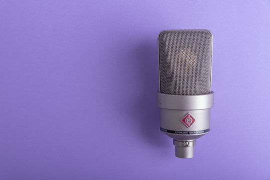 Uzhgorod, Ukraine - December 1, 2019: Large diaphragm condenser studio microphone Neumann tlm 103 on a purplebackground.