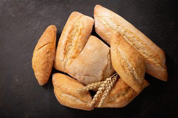 fresh bread with wheat ears, top view