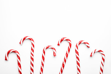 Frame made with Christmas candy canes on white background. Minimal composition with peppermint...