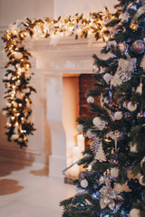 Christmas tree and Christmas lights in a room by the fireplace