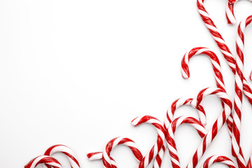 Frame made with Christmas candy canes on white background. Minimal composition with peppermint candies. Top view - Powered by Adobe
