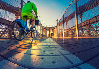 a magnificent view of Brooklyn Bridge with cyclist , New York City