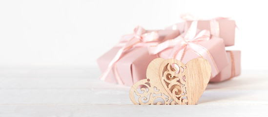 Valentine's Day. Gifts in pink boxes and golden hearts on a light background, festive background, wedding, birthday