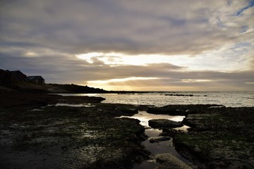 sunset on coast of sea