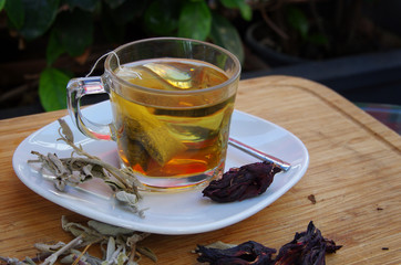 a cup of salvia tea served with raw salvia