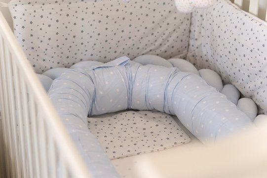 baby crib with nest mattress and pillow.