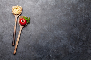 Pasta and ingredients in spoons