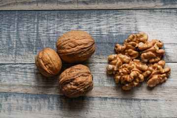 walnut kernels and walnut shells on wooden table
