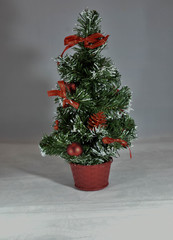 Christmas tree in brown pot on gray white background