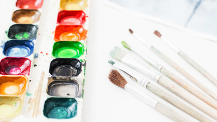 Fine art. Creative hobby inspiration. Watercolor palette brush set on white background.