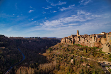 Fototapeta na wymiar To outsiders, Pitigliano looks like a fairytale village, jetting from striking, wild ridges and surrounded by lush valleys carved by the Lente and Meleta rivers