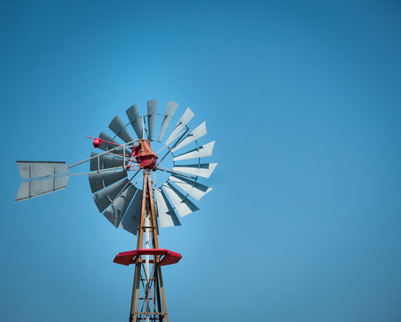 Antique windmill on a texan farm with clear sky on a sunny day