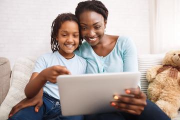 Afro mom and daughter making video call