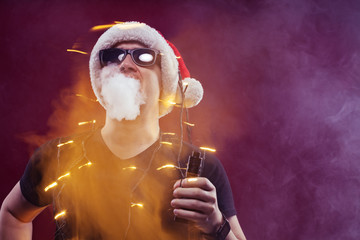 Vaping man in santa claus hat and a cloud of vapor