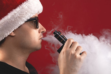 Vaping man in santa claus hat and a cloud of vapor