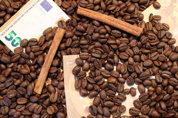 Texture of roasted coffee beans cinnamon sticks and 50 Euro bills.