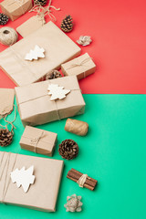Zero waste Christmas composition. Gifts wrapped in brown craft paper, pinecones, cinnamon sticks, jute twine and woden ornaments for decoration, selective focus