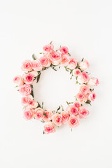 Flat lay frame border with blank copy space mockup made of pink rose flower buds on white background. Top view floral concept.