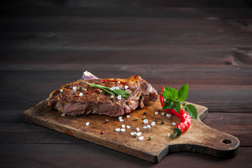 Fried beef steak on wooden board