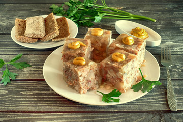 aspic with mustard, bread  and parsley on a dark wooden background
